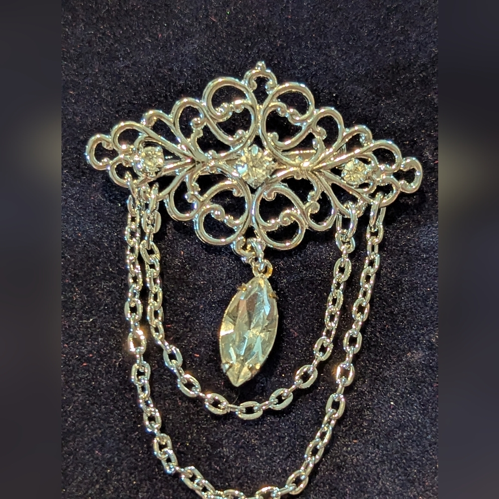 Elegant Silver Brooch with Chain Detailing